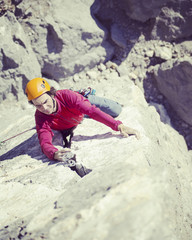 Rock climber on a face of a cliff