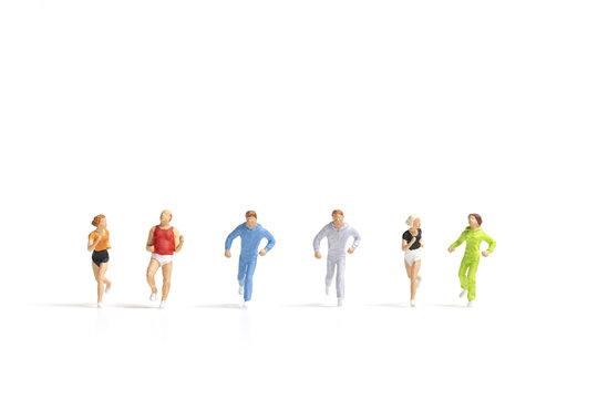 Miniature people running on white background , Healthy lifestyle and sport concepts.
