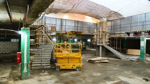 builders install modern stairs to upper level platform in mall hall