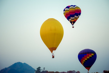 Colorful hot air balloon over mountain on sky sunset , vintage and retro filter effect style. balloon carnival in Thailand