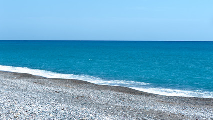 Beautiful blue sea and stony shore