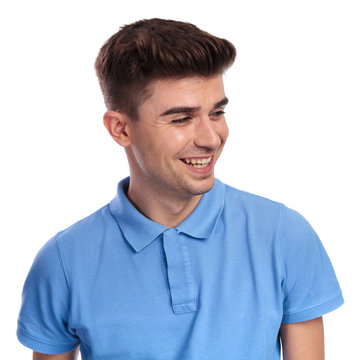 laughing young casual man looks to side