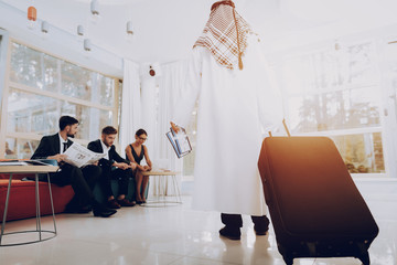 Arabian Businessman Holding A Suitcase In Office.