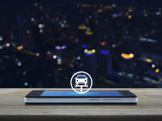 Service fix car with wrench tool icon on modern smart mobile phone screen on wooden table over blur colorful night light city tower and skyscraper, Business repair car online concept