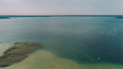 Aerial view of the lake. People are swimming. Boats. Summer. Sky. Ukraine.