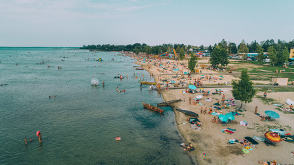 Aerial view of the beach. Transparent lake. People are sunbathing. Summer. Ukraine.