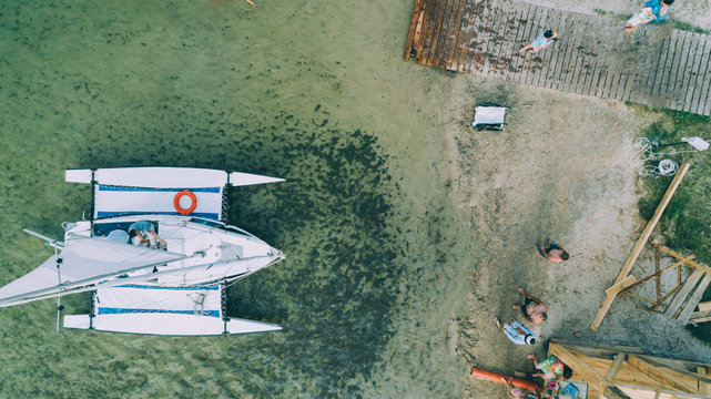 Aerial view of the yacht in the lake. Summer. People. Beach. Berth. Ukraine.