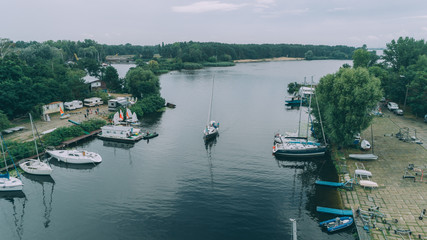 Yacht club Orion. July 21, 2018. Kiev (Kyiv). Ukraine. Aerial view of a yacht in the sea. People. Berth. The yacht emerges from the bay.