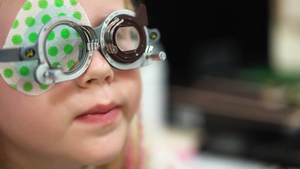 Eyesight check. Caucasian girl who have vision disabilities.Medical treatment and Rehabilitation