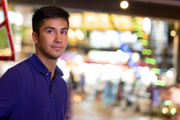 Fototapeta premium Portrait of mixed race young man model looking at camera with co