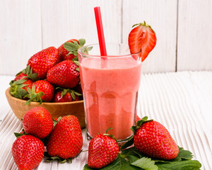 fresh strawberrysmoothie or milkshake on a wooden rustic background