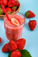 fresh strawberrysmoothie or milkshake on a delicately blue background