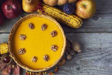 Fresh and tasty homemade pumpkin pie over wooden backgound
