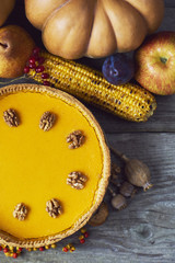 Fresh and tasty homemade pumpkin pie over wooden backgound