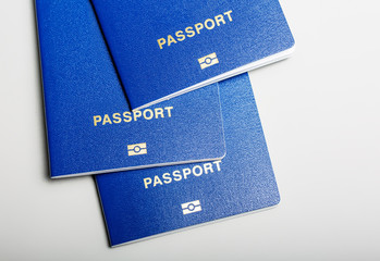 three blue biometric passport with identification chip on white background