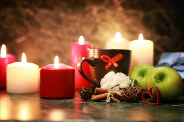 night cup of tea with candle and apple