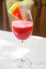 Watermelon cocktail in a glass with a slice of watermelon for decoration. Summer fruit cooling healthy drink