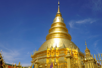 Fototapeta premium Golden pagoda with beautiful blue sky and respected people.