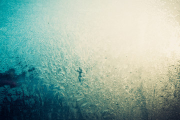 Frosty pattern on the glass, blue yellow color.