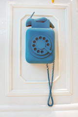 Hanging phone blue tube in the form of shoes.