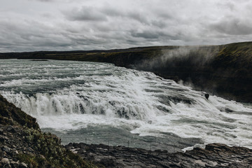 aerial view of beautiful Gullfoss waterfall under cloudy sky in Iceland