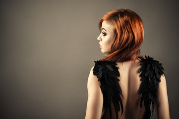gorgeous redhead woman with black wings