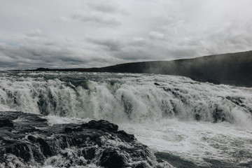 scenic view of beautiful mountain river flowing through highlands in Iceland
