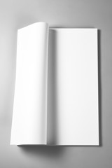Blank open book or magazine with curled upper page