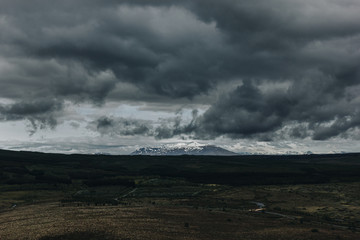 scenic view of landscape with mountains covered by snow under cloudy sky in Iceland
