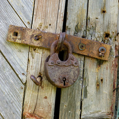 Old lock on the door. lock on the door of an old farmhouse . true village style