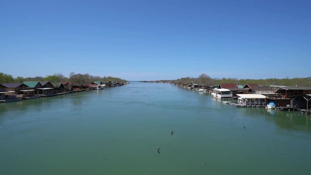Ada Bojana, Montenegro - April 2018 : Small wooden houses and restaurants on the riverbank of the Ada Bojana river near Ulcinj, Montenegro