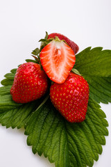 Juicy fresh strawberry on a white acrylic background