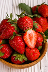 Juicy fresh strawberry on a rustic wooden background