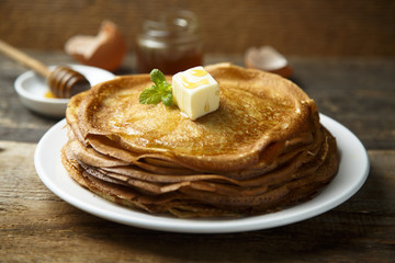 Homemade crepes with honey and butter