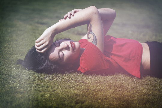 beautiful hipster lying on the grass
