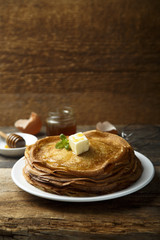 Homemade crepes with honey and butter