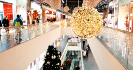 Blurry Christmas decorated shopping center with two floors and buyers. Crowd of people in Christmas black friday big sales, timelapse