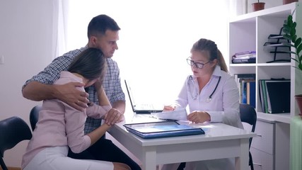 women health, frustrated couple with infertility problem sitting in front of their female doctor at the medical office - Powered by Adobe