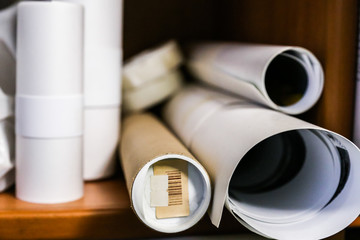 White rolled papers organized on a shelf
