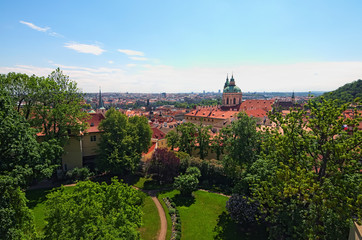 Skyline aerial view of old town Prague, ancient buildings and red tile roofs against blue sky. Selective focus with wide angle lens. Spring sunny day. Prague. Czech Republic