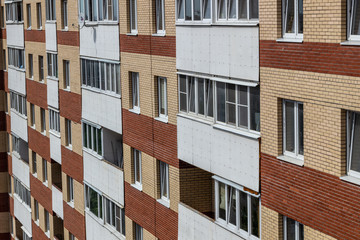 White balconies on the building of red brick