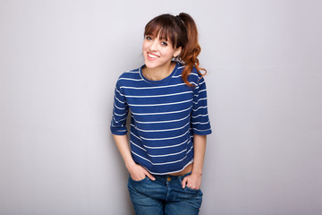 smiling young woman against gray wall