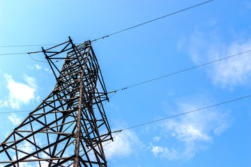 Power line support against blue sky background