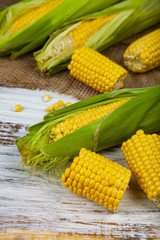 Ripe corn on a wooden table.