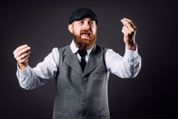 A bearded man in suit talking and gesticulating like italian on black background