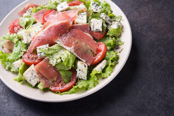 Fresh salad with hamon, tomato, lettuce and cheese blue