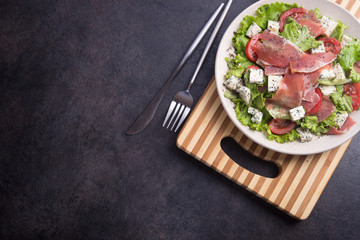 Fresh salad with hamon meat, tomato, lettuce and cheese blue