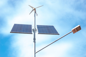 Eco-friendly street lamp with solar panels and a wind turbine