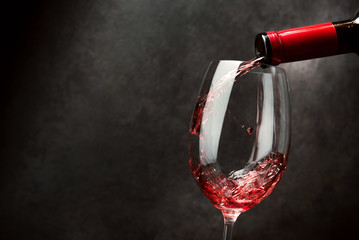 Red wine pouring into wine glass