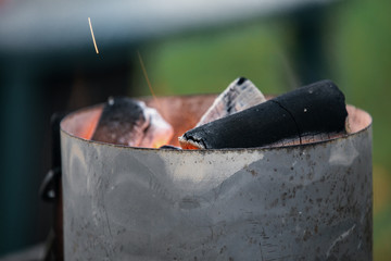 Close up burning charcoal in metal bowl